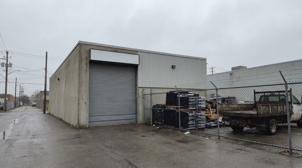 Roofing company shop and yard with business signage out front